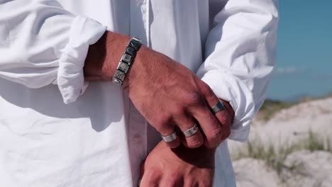 nervous man hands playing and fidgeting with rings and bangles
