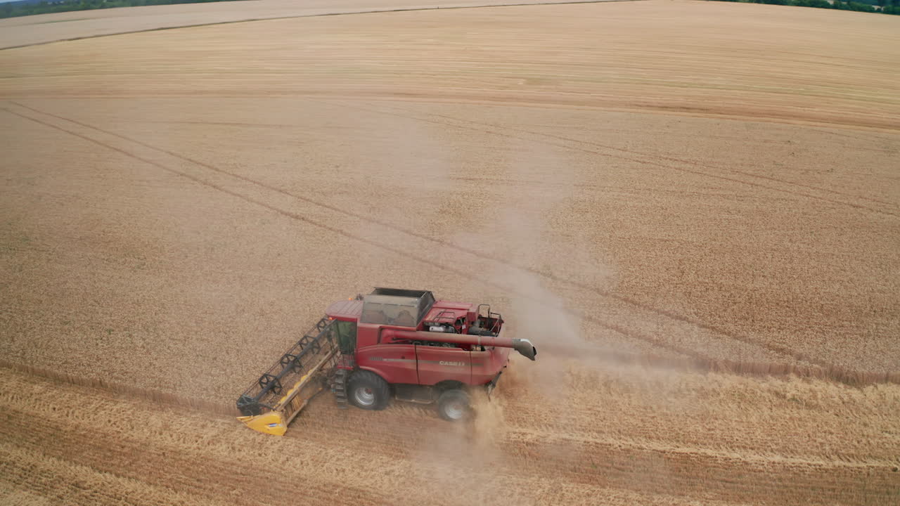 Aerial view of combine harvesting wheat in a field