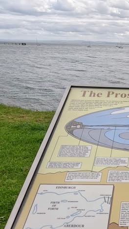 cloudy day at aberdour beach with informational sign