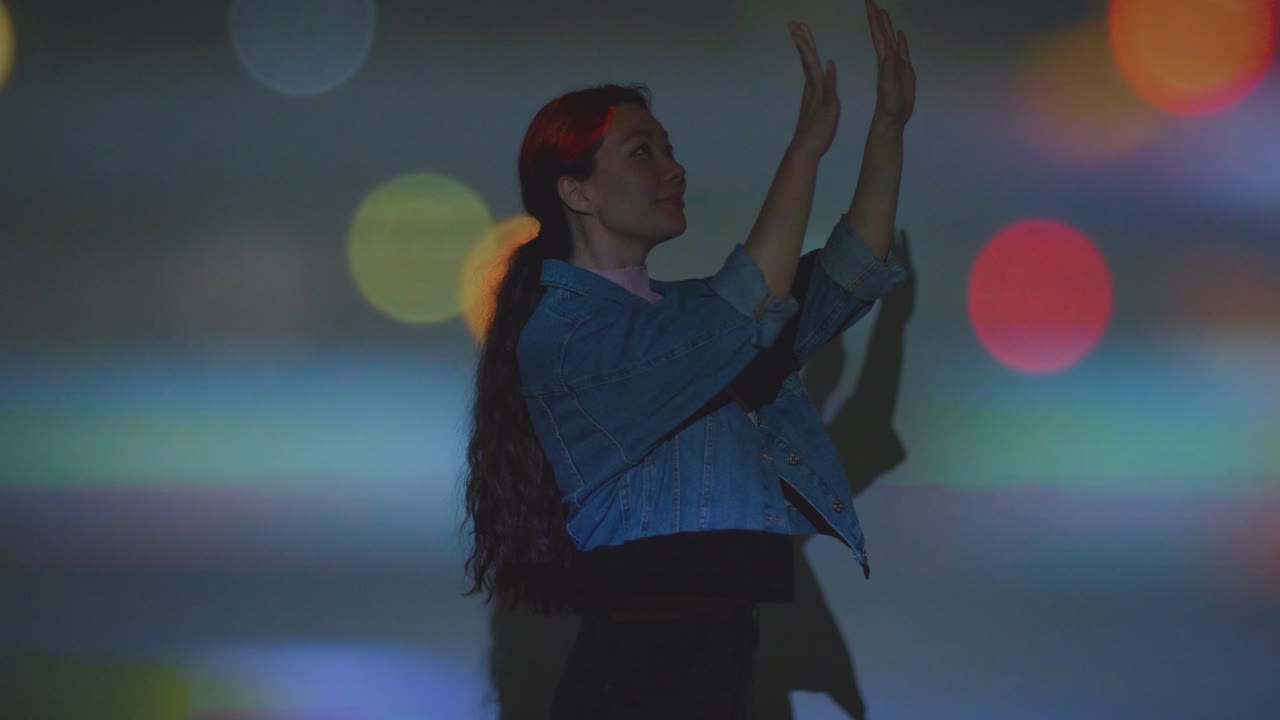 mujer visitando una exposición de arte inmersiva con imágenes de una ciudad ocupada siendo proyectadas en su cara