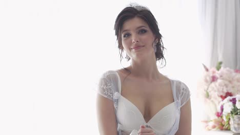 slow-motion-closeup-bride-in-white-bra-breathes-deeply