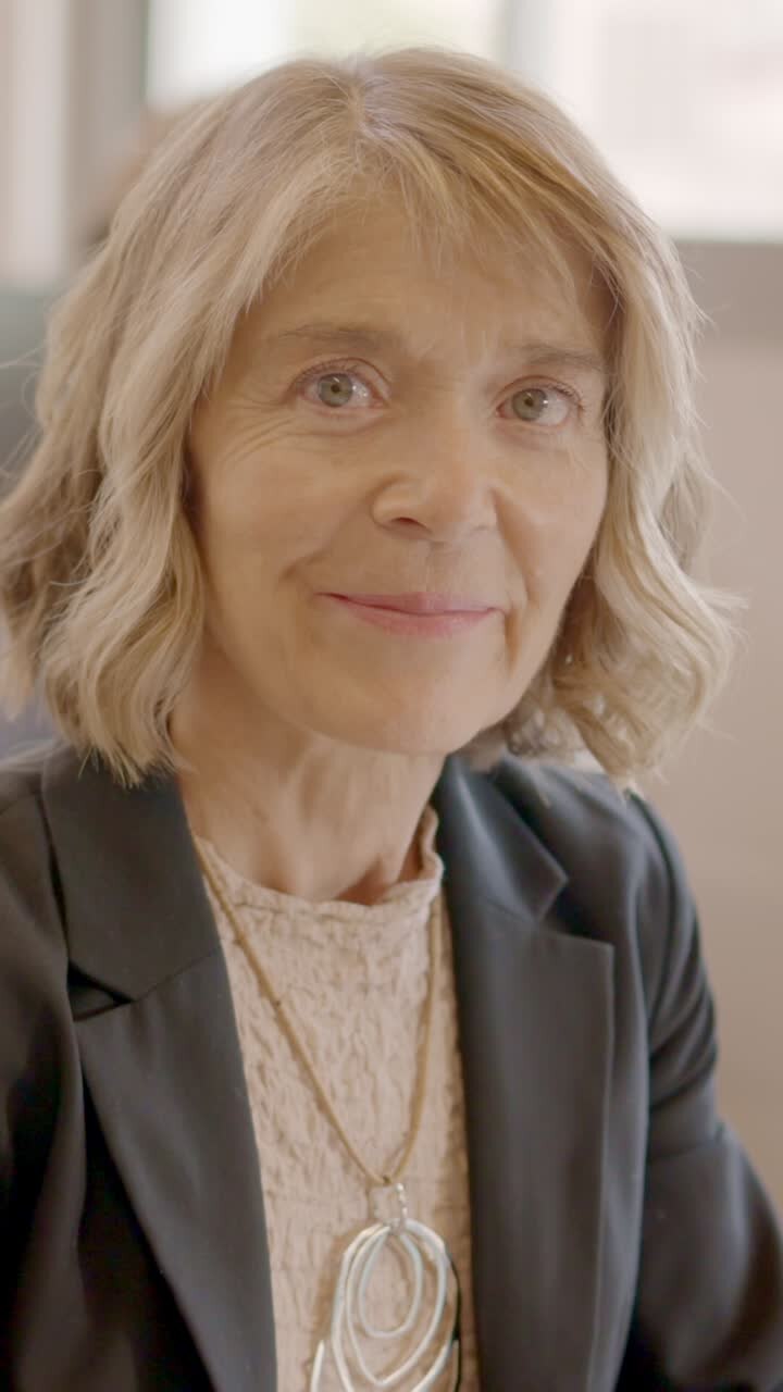 Woman working with computer and smiling in a coworking desk