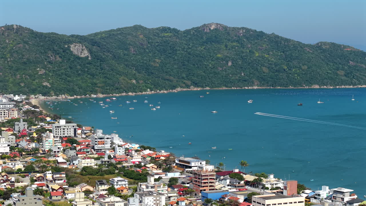 Coastal Cityscape with Mountains and Boats
