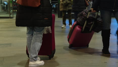 passengers waiting at a train station or airport