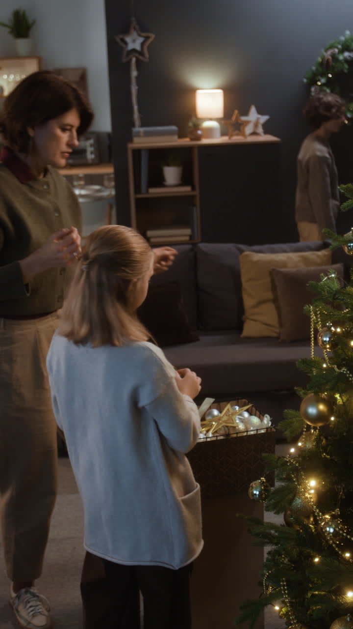 Mother and Daughter Decorating Christmas Tree