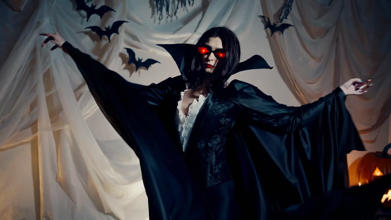 A low-angle video captures a mysterious vampire in a flowing black cape, surrounded by Halloween