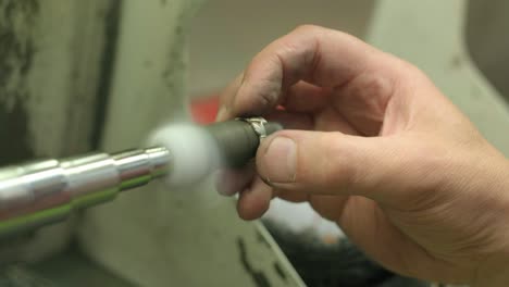Close ups of a craftsman making jewellery in a workshop
