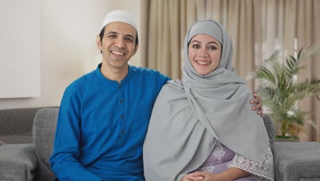 happy muslim couple talking to the camera