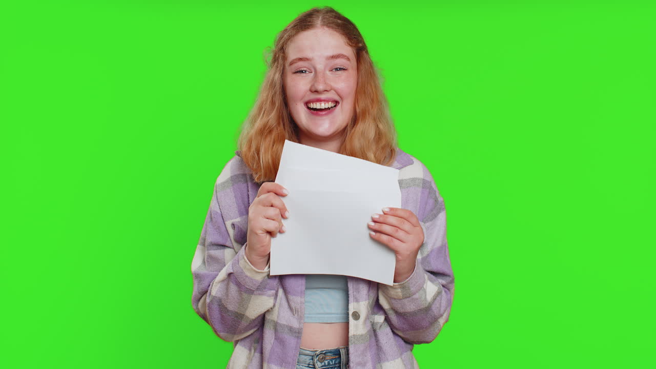 Happy young woman open envelope take out letter reads bank loan approve great news award win