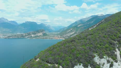 breathtaking vista of torbole, lake garda, amidst nature's splendor with towering rocks, expansive sky, and ever-changing clouds, offering an invigorating hiking adventure in lomba