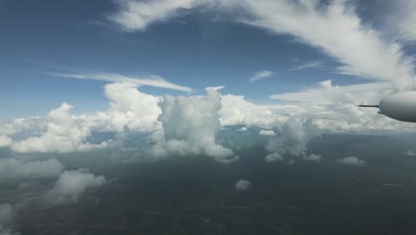clouds floating in the air seen from cessna 208b grand caravan flying in high altitude. pov