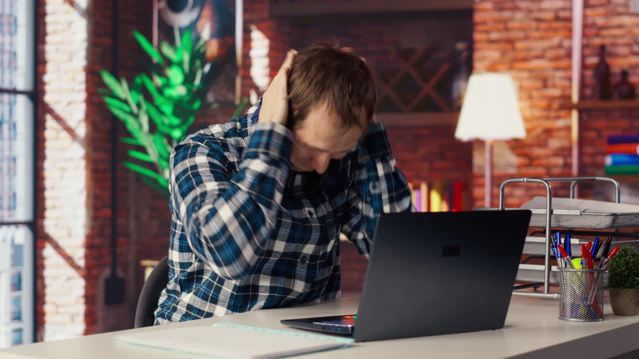 Exhausted freelancer feeling overworked while typing on device keyboard