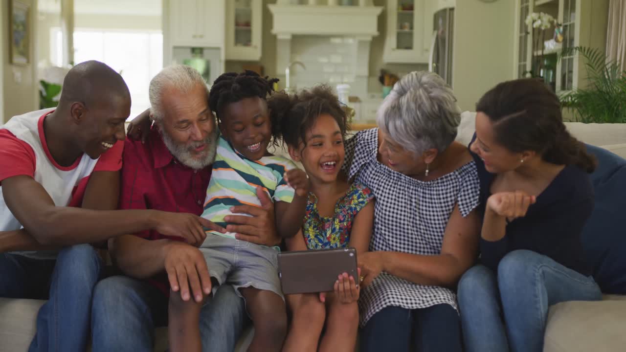 Three generation family using digital tablet at home