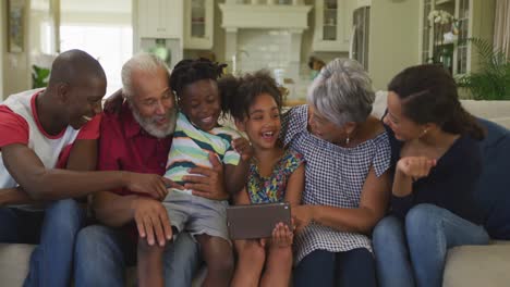 three generation family using digital tablet at home