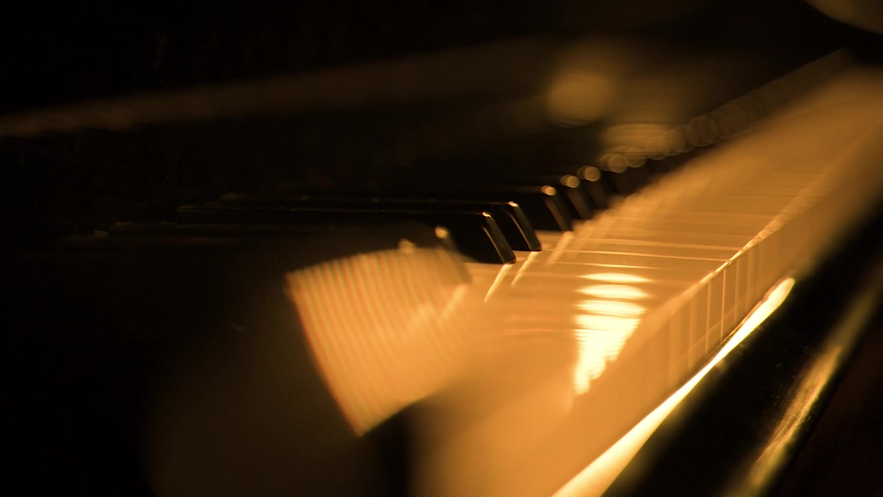 Grand piano keys, nearest keys in sharp focus while the background fades into a soft blur, bathed in the golden glow of candles, close up shot