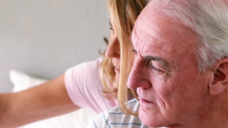 Happy-senior-couple-interacting-with-each-other-on-bed