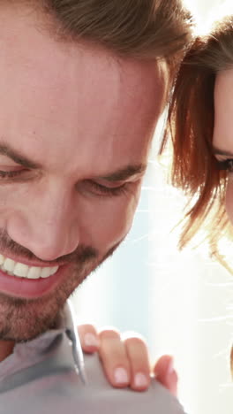 smiling couple with engagement ring