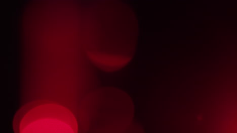 abstract analogue footage featuring red bokeh drifting slowly in soft focus. warm crimson hues and handmade texture make it perfect for overlays, installations, or dreamy visual designs.