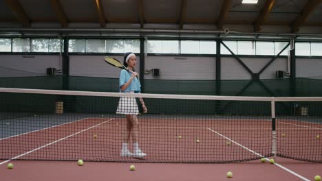 teenage girl playing tennis indoor