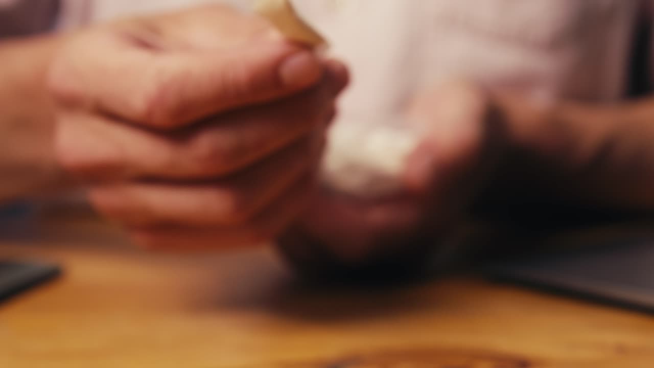 Snus nicotine tobacco close up, pack of tobacco for gum. unhealthy addiction. Man opening box with snus and taking one.