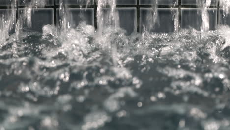 Close-Up-Drops-of-Water-From-Fountain-Colliding-in-the-Pond-Forming-Ripples