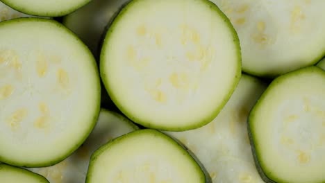 round slices of zucchini slowly rotate.