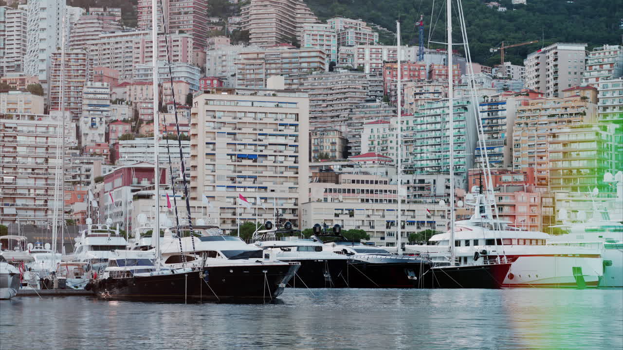 View of boats docked in the Monaco Marina with the skyline of the city on the background
