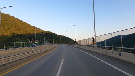 Driver's-POV---countryside-road-between-Mountains-in-South-Korea-on-sunset