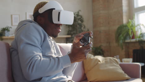 black man enjoying video game on vr headset at home