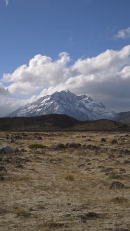 mount cook against blue sky and clouds in south island, new zealand - vertical shot
