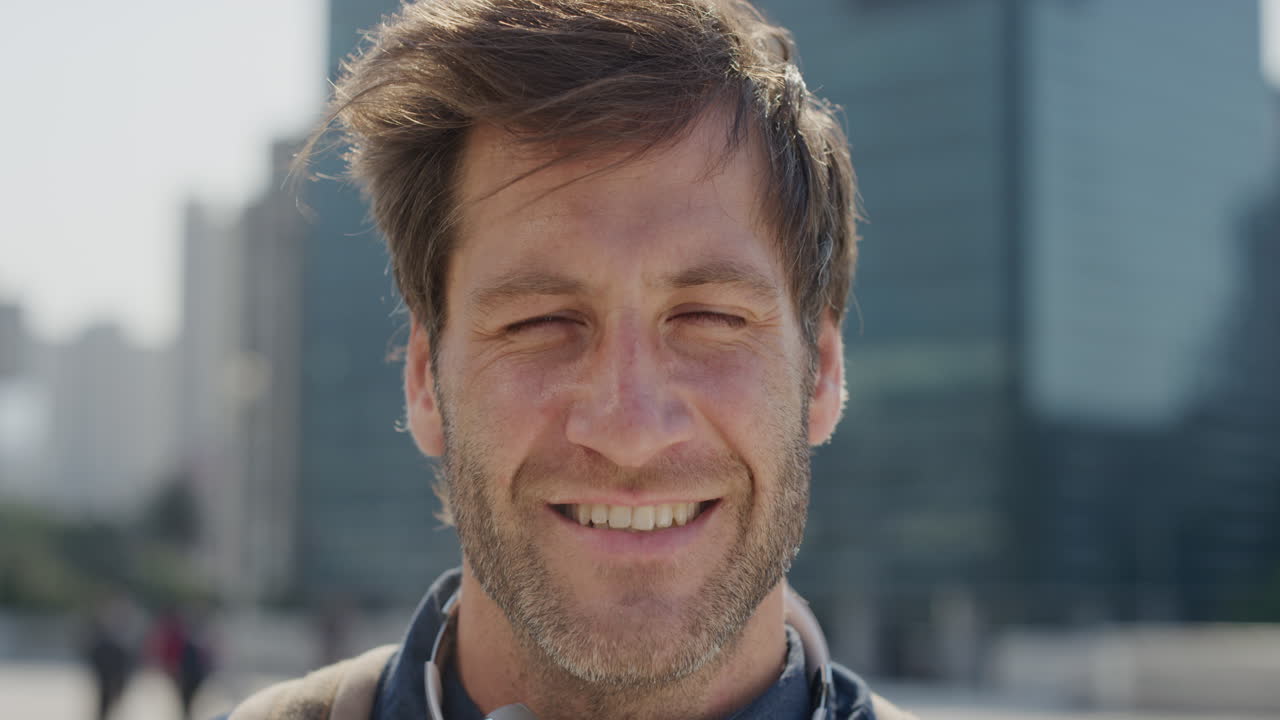 close up portrait attractive young man smiling enjoying successful urban lifestyle happy businessman looking cheerful in city slow motion