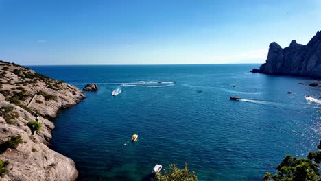 A-breathtaking-view-of-boats-cruising-along-the-clear-blue-waters-of-Juniper-Grove,-New-World