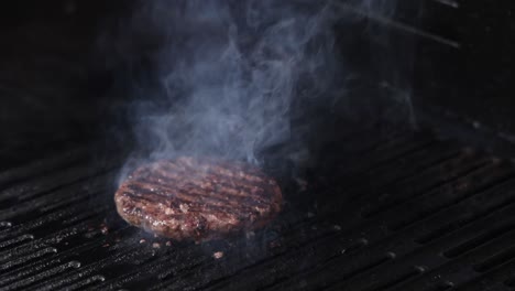 burger patty grilling with sudden flame burst