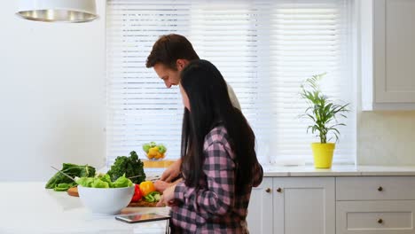 pregnant woman talking to man while cutting vegetable 4k