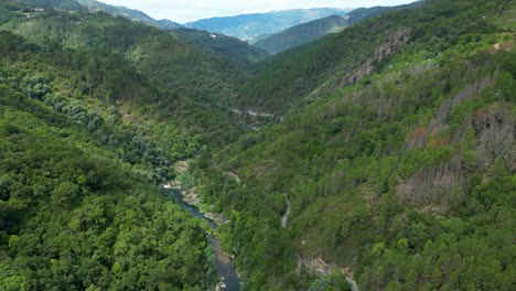 Geres-National-Park-River-and-Waterfall-Landscape-in-Fafião,-Captured-on-a-Sunny-Day-with-Green-Trees---Birds-Eye-View