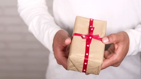 hands holding a wrapped gift