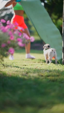 woman exercising with her dog in the park