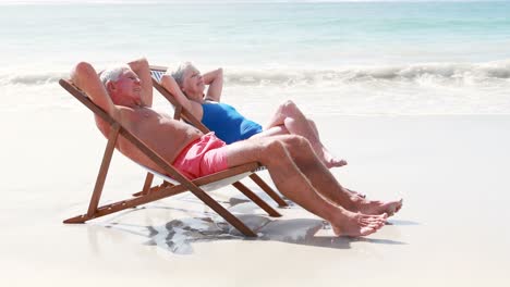 retired old couple lying on deckchair