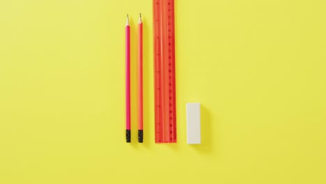 video of pencils, ruler and eraser on yellow background