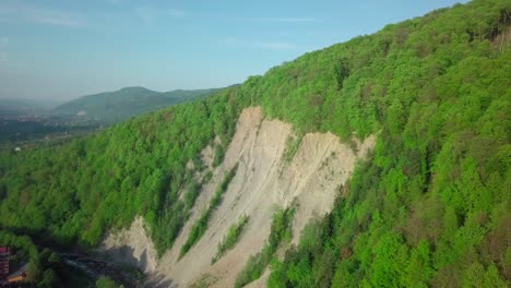 the landslide on the river. aerial drone footage view: flight over spring mountain village with forest in sunrise soft light. alps, switzerland, europe. majestic landscape. beauty. concept of pure nature, natural food, lack of chemicals