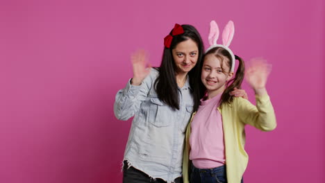 Lovely-schoolgirl-with-bunny-ears-an-her-mom-waving-on-camera
