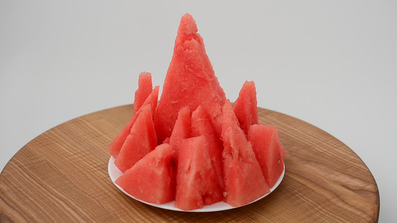 Shooting of a watermelon on a kitchen board. Shooting in the movement
