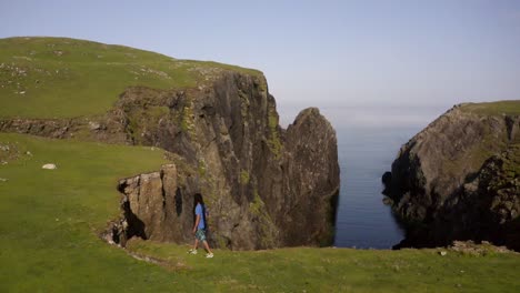 Man-walks-on-a-cliff-edge