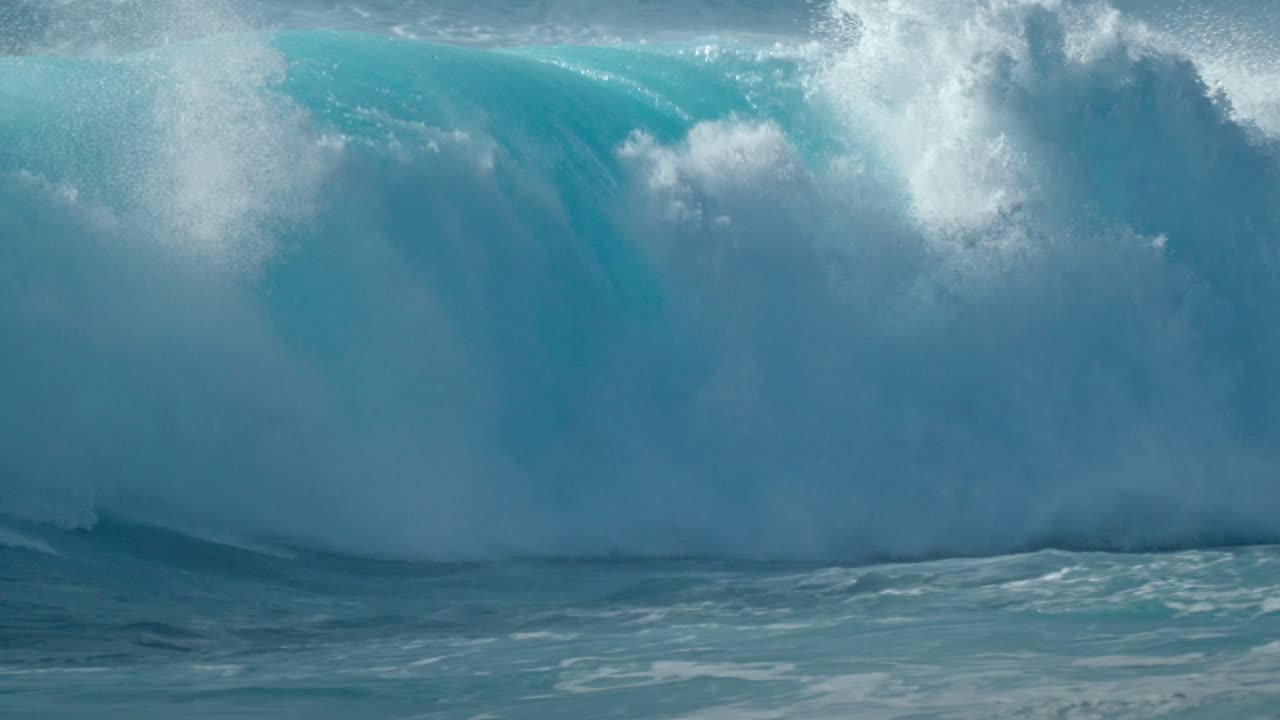 Dramatic ocean waves collide with the volcanic coastline near Timanfaya National Park, located on the island of Lanzarote in the Canary Islands, Spain.