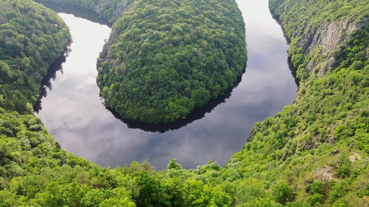 Vltava River meandering through green hills from Viewpoint Máj at sunset, drone