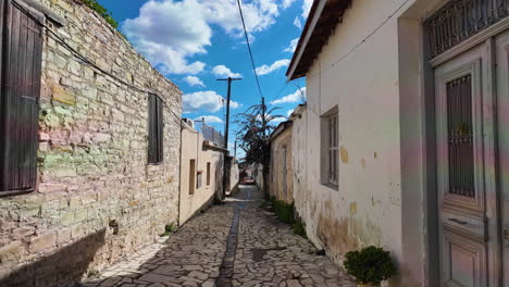 Narrow-alley-in-Lefkara-with-stone-houses-and-a-clear-blue-sky