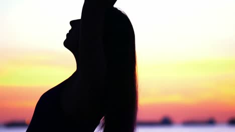 woman performing yoga on the beach