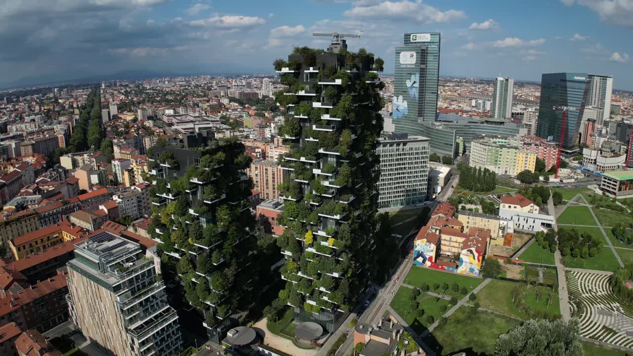 A bird's-eye view in 4K captures a sprawling European city, highlighting a large building with cascading greenery covering its walls from top to bottom