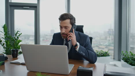 dissatisfied boss arguing phone conversation with employees at office close up.