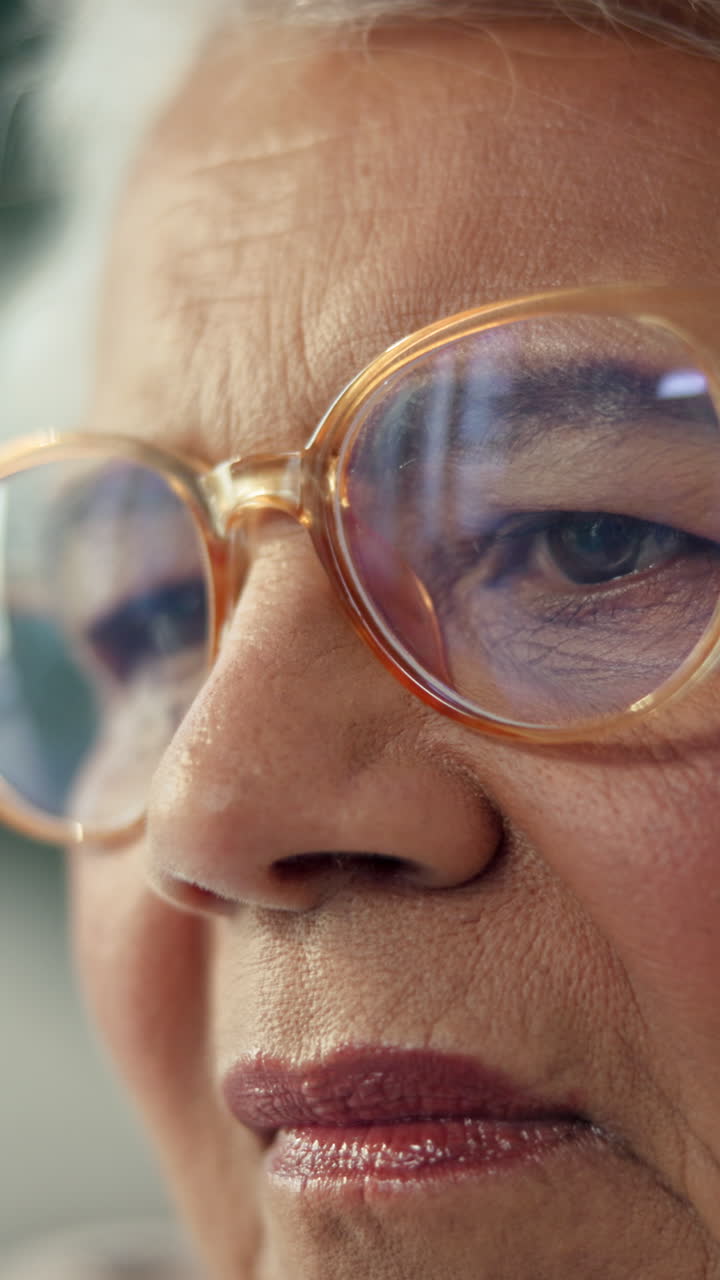 Close-up of Senior Woman's Face with Glasses Blinking